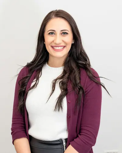 Original photo: a woman with dark hair in a maroon cardigan