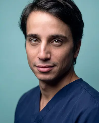 AI example made from that photo: the same man in navy scrubs on a teal background