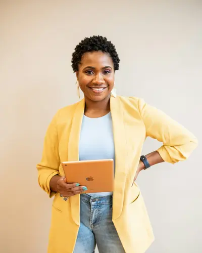 Original photo: a woman in a yellow blazer holding a tablet