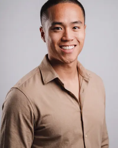 AI example made from that photo: the same man in a tan shirt on a light gray background