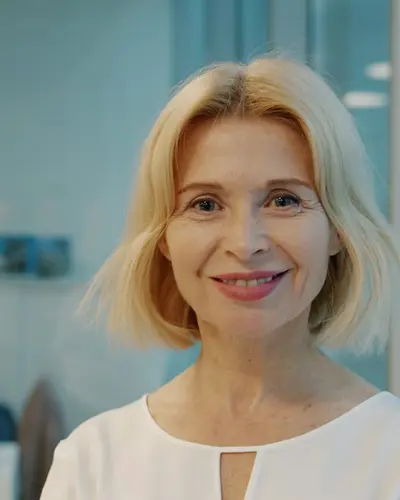 Original photo: a blonde woman in a white top in an office