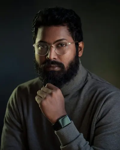 Original photo: a bearded man with glasses in a dark sweater