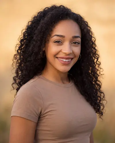 AI example made from that photo: the same woman in a tan t-shirt outdoors in golden light