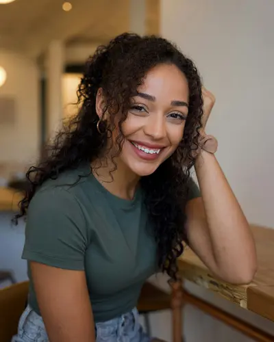 Original photo: a young woman with curly hair in a green t-shirt