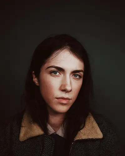 Original photo: a woman with dark hair in a jacket with a fleece collar
