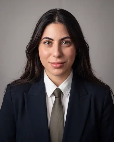 AI example made from that photo: the same woman in a suit and tie on a gray background