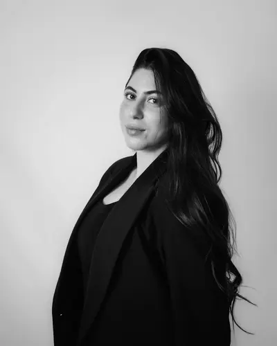 Original photo: a woman with long dark hair in a black blazer, black and white photo