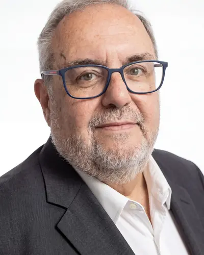 AI example made from that photo: the same man in a gray blazer in a white room